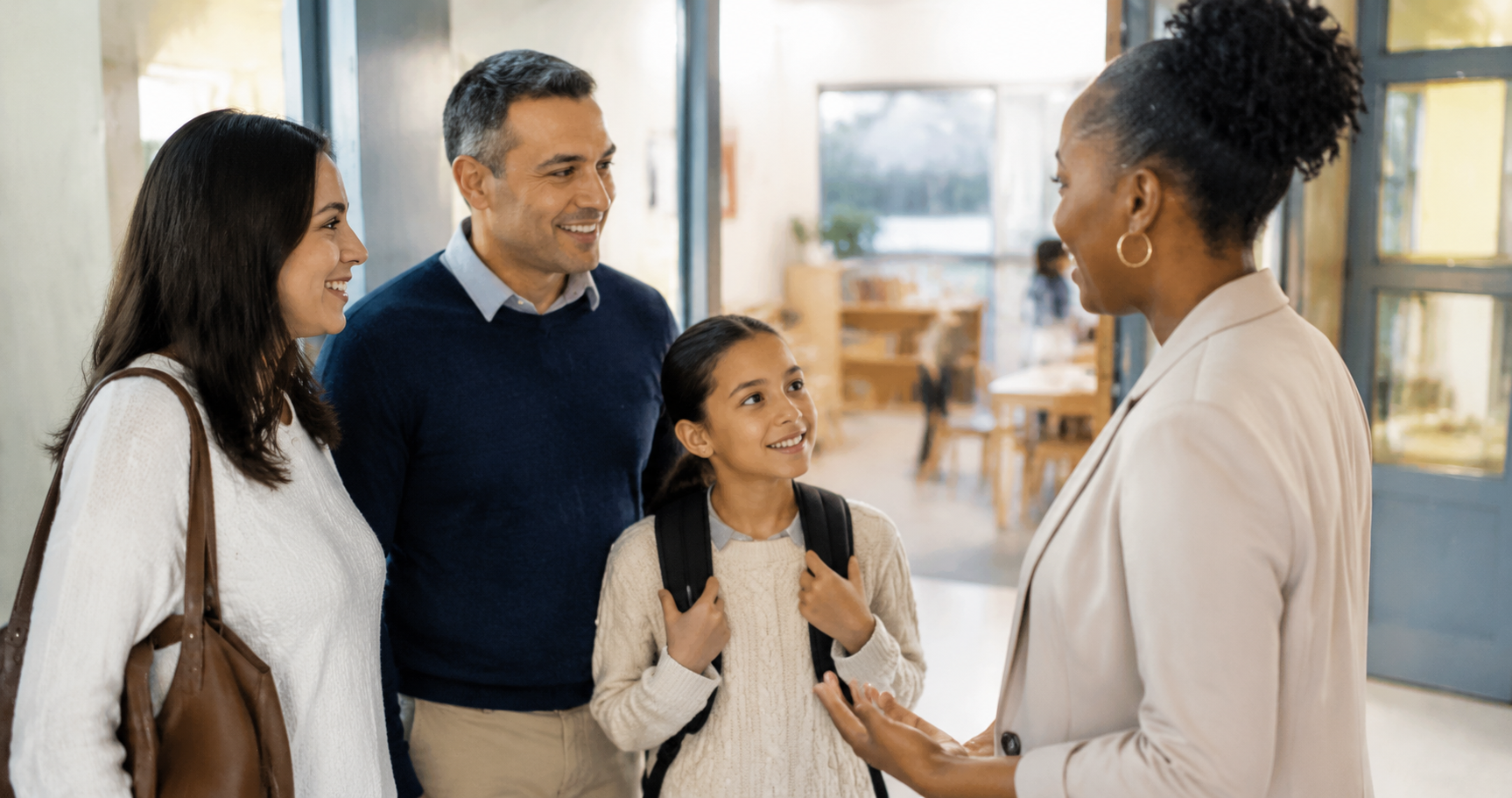 Illustrative photo of a family speaking with an educator during a school tour